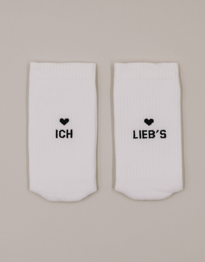 Weiße Socken Ich Lieb's von Eulenschnitt mit schwarzem Schriftzug an der Ferse und schwarzen Details
