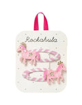 Zwei Pink Pony Haarspangen von Rockahula mit glitzernden Ponys, goldenen Kronen und gestreiften Klickspangen.