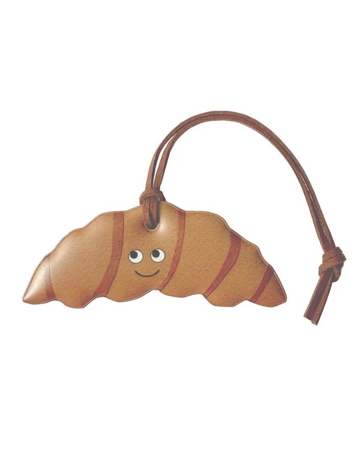 Firefly Reflectors Taschenanhänger Croissant, reflektierender Sicherheitsanhänger in Croissant-Form, ca. 8 cm Durchmesser.