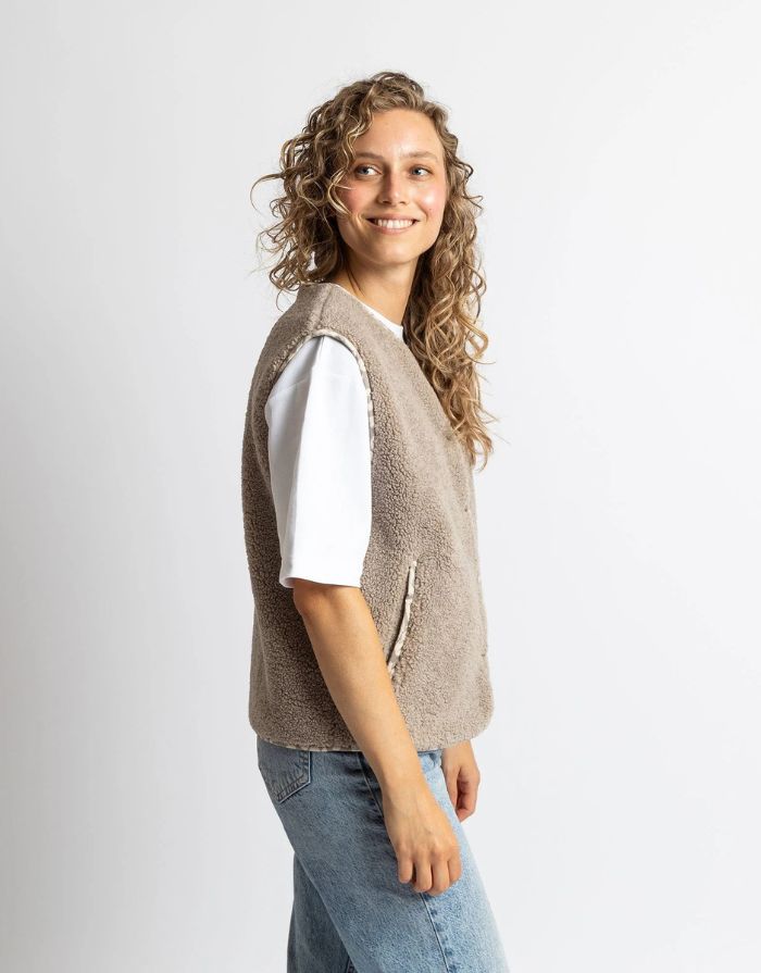Teddy Fleece Weste in Mushroom von VIVI MARI, loose fit, flauschiges Innenmaterial, zwei Paspeltaschen, dezente Leo-Details, nachhaltig aus 100 % recyceltem Polyester.
