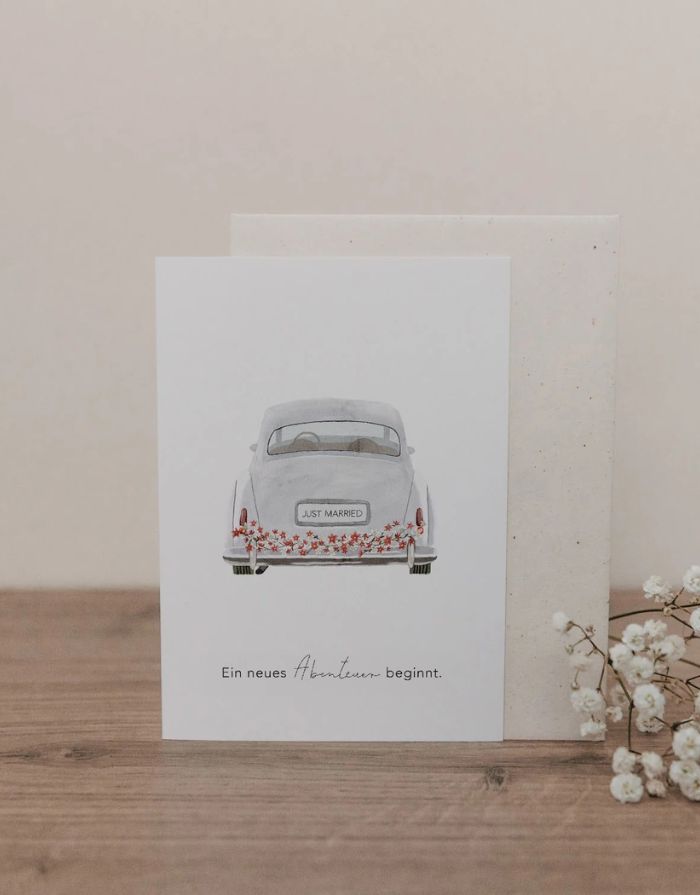 Klappkarte mit Umschlag von Eulenschnitt mit einem Bild von einem VW Käfer und der Aufschrift Ein neues Abenteuer beginnt